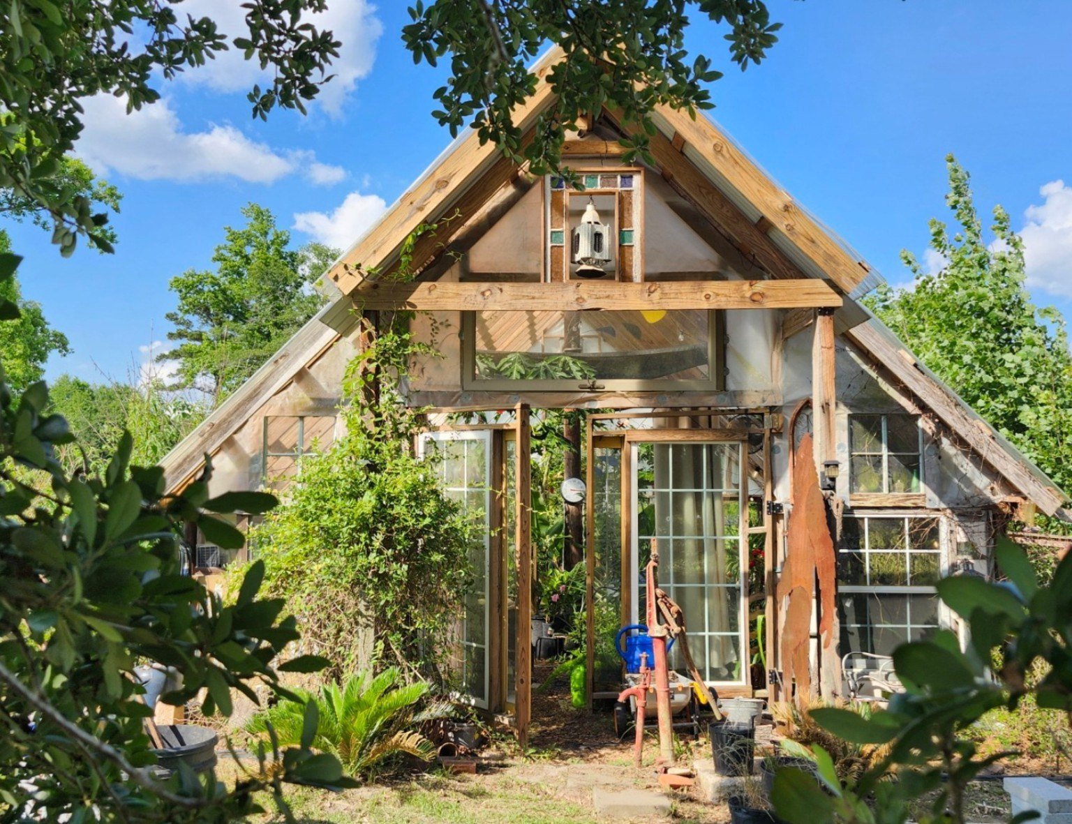The greenhouse front in summer sun, built from reclaimed windows